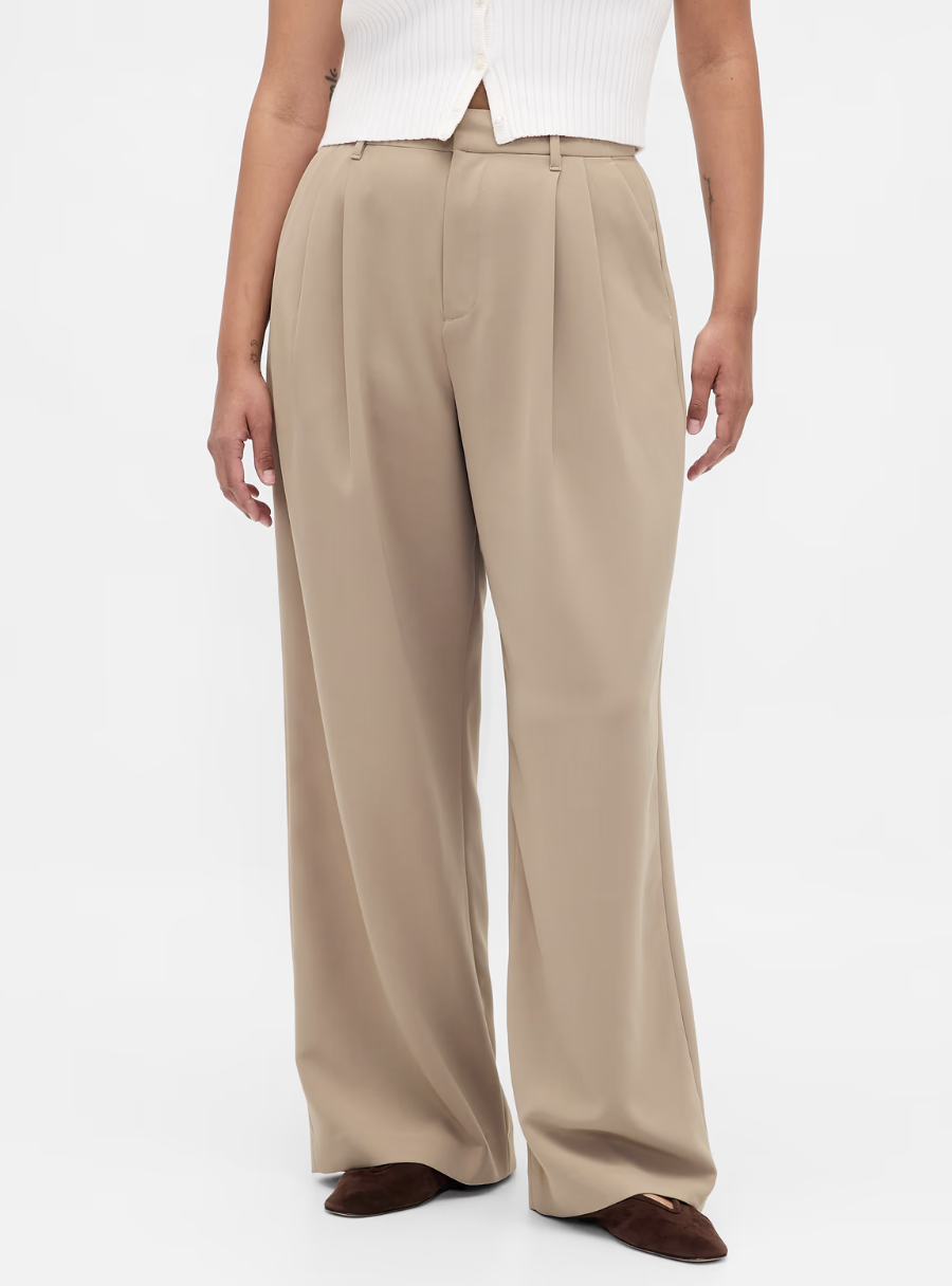Model wearing high-waisted espresso brown tailored wide-leg trousers paired with burgundy pointed-toe flats on a white background.