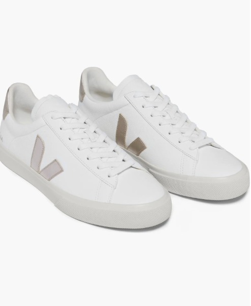 A product shot of the Veja Campo Sneaker in white leather with a neutral taupe suede "V" logo and heel tab, featuring a thick off-white sole.