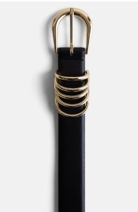 A close-up of a black faux-leather belt featuring four gold metal loops and a polished gold buckle from the Scoop x Devil Wears Prada collection.