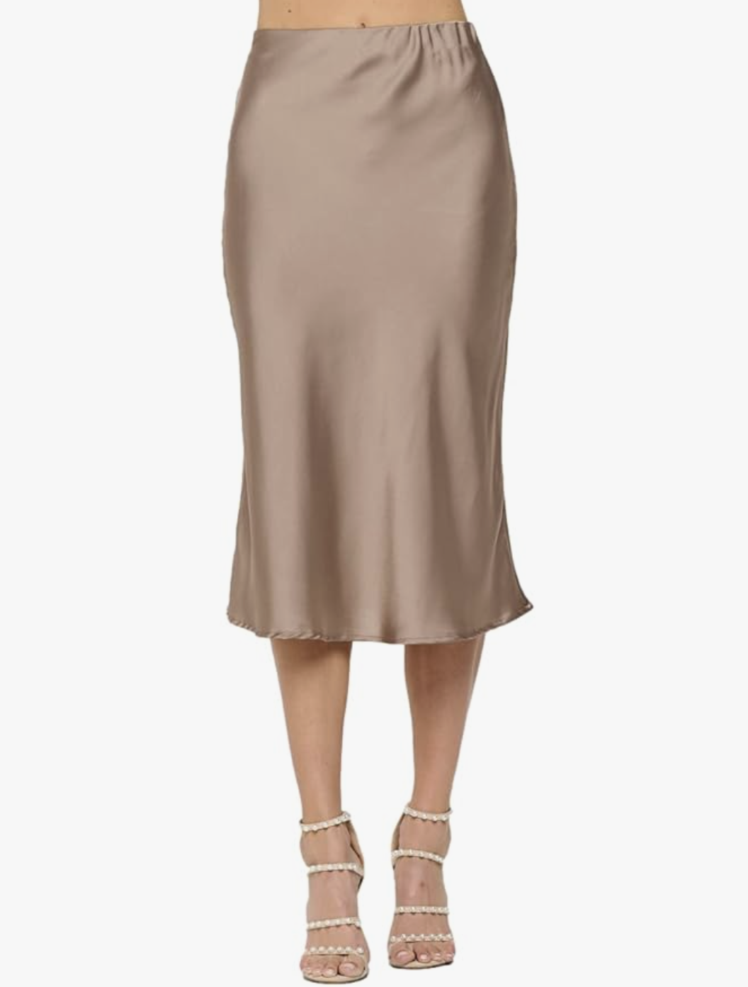 A woman wearing a champagne-colored Satin Midi Skirt paired with pearl-embellished heels, demonstrating a timeless and sophisticated quiet luxury aesthetic.