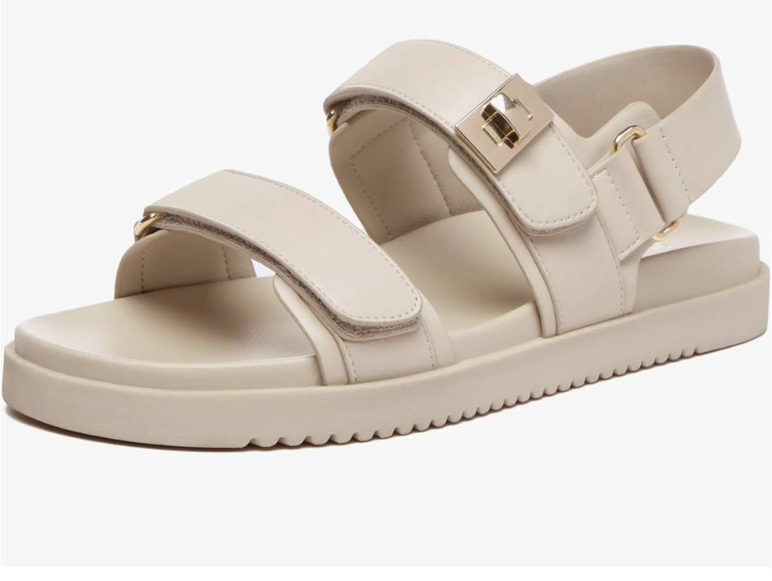 A pair of beige double strap slip-on leather footbed sandals from Amazon, perfect for a casual summer BBQ outfit.