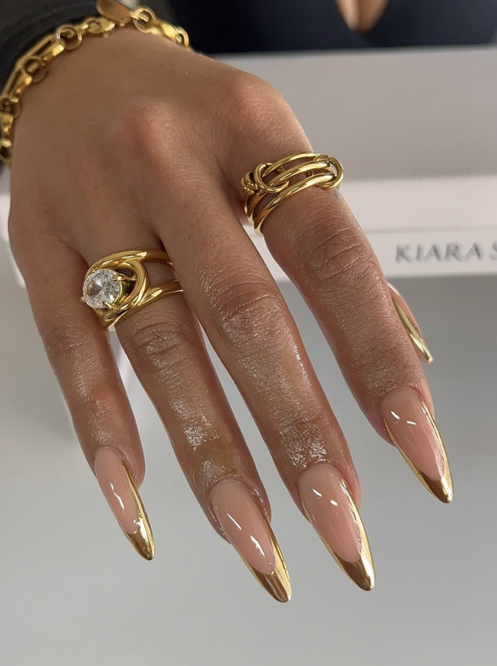 Long almond-shaped nails with an ultra-glossy glazed donut chrome finish, highlighting clean and cute June nail ideas.
