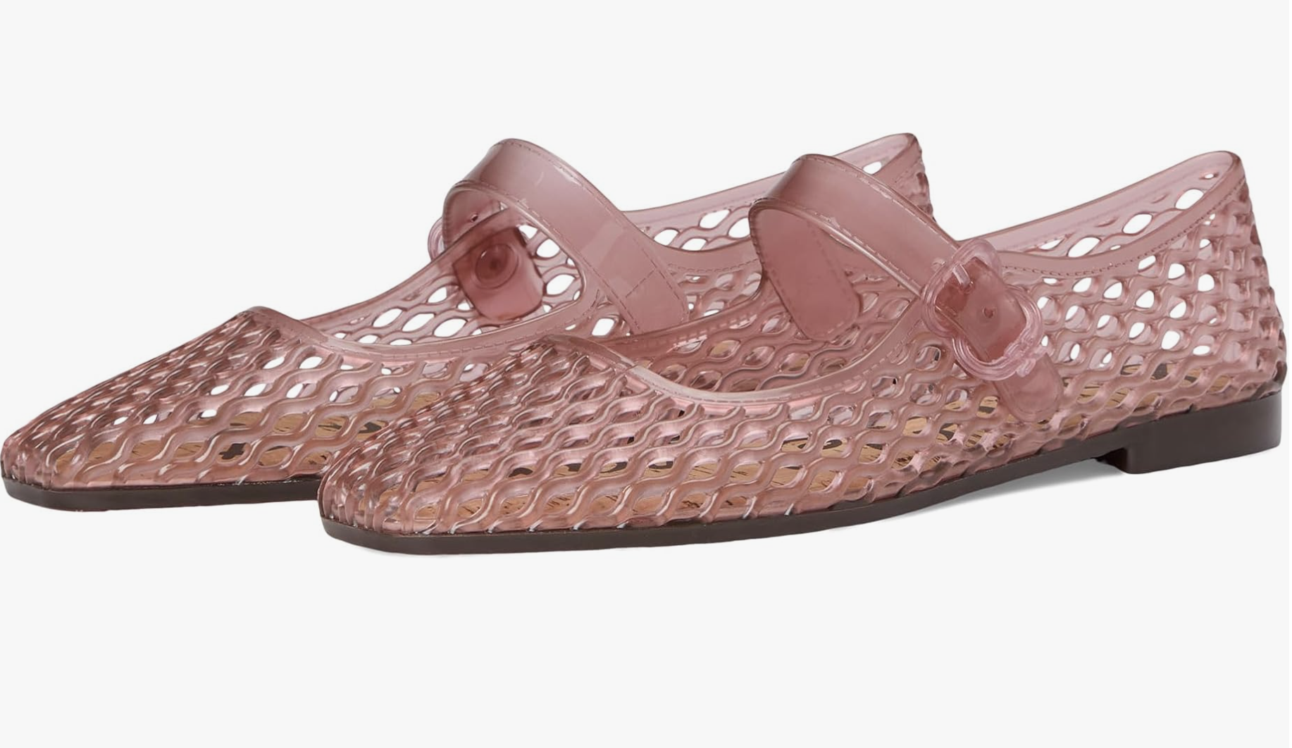 A pair of pink translucent jelly Mary Jane flats with a woven texture and a buckled strap on a transparent background.