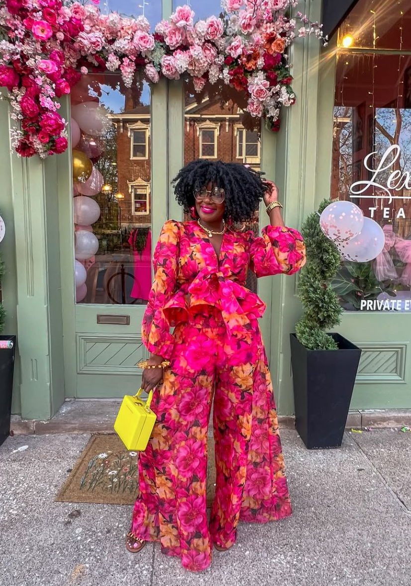 woman wearing a stylish and bold floral outfit that's also modest