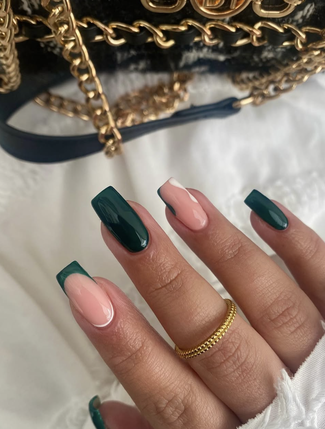 Deep forest green manicure on almond-shaped nails