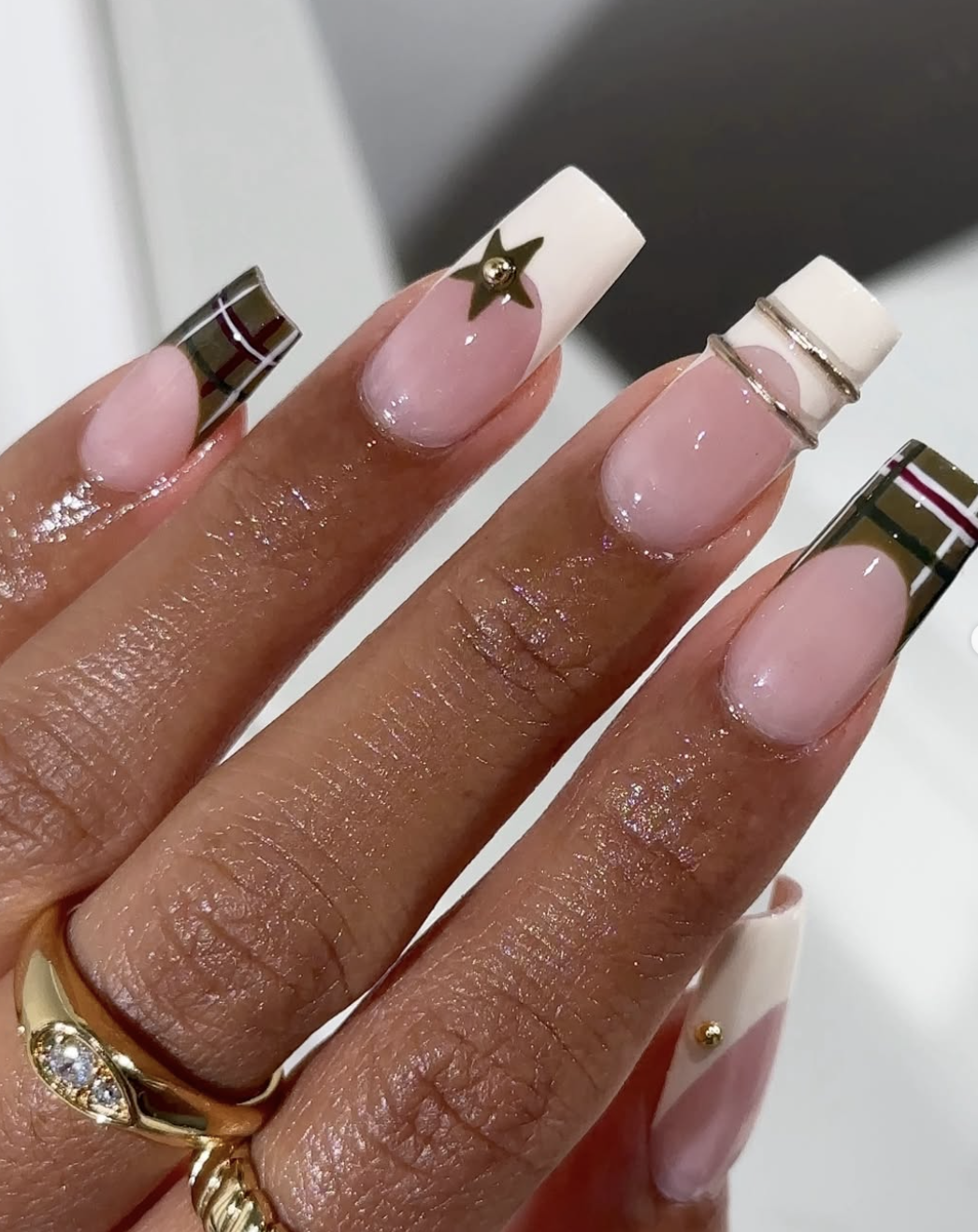 Close-up of plaid accent french on neatly manicured hands