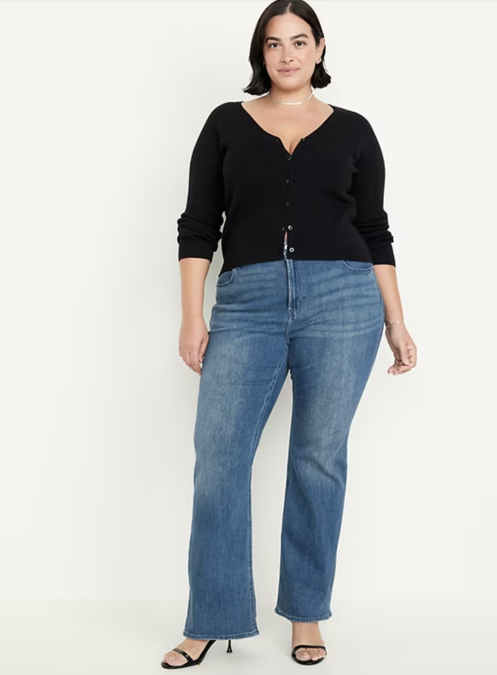 Plus-size woman wearing Old Navy Wow flare jeans in a medium wash with a high-rise fit.