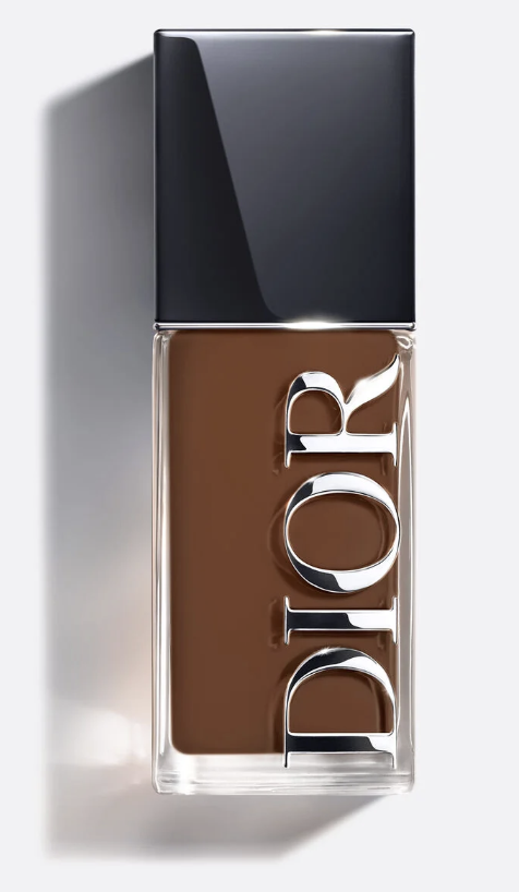 A close-up of the Dior Forever Skin Glow Foundation bottle showing the rich liquid makeup formula through the glass.