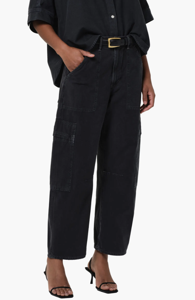 A pair of black low-waisted parachute cargo pants with an oversized wide-leg fit and adjustable drawstring waist and hem.