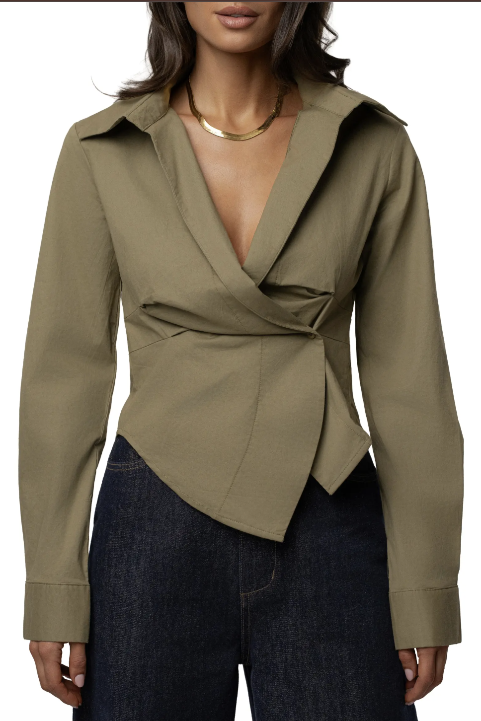 Muted olive green long-sleeve draped wrap blouse styled with high-waisted dark denim.