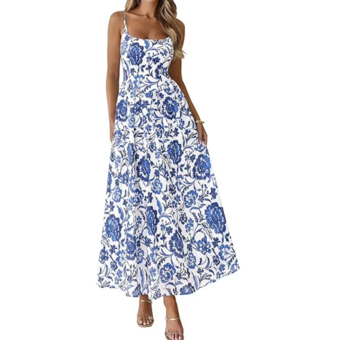 A woman wearing a blue and white floral print sleeveless maxi dress with a square neckline and tiered skirt.