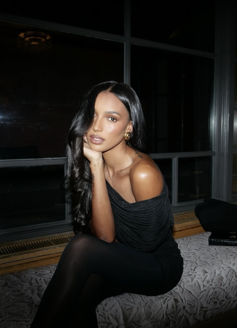 Model Jasmine Tookes wearing a chic black ensemble, embodying the "Quiet Luxury" aesthetic for a Longines watch style guide.