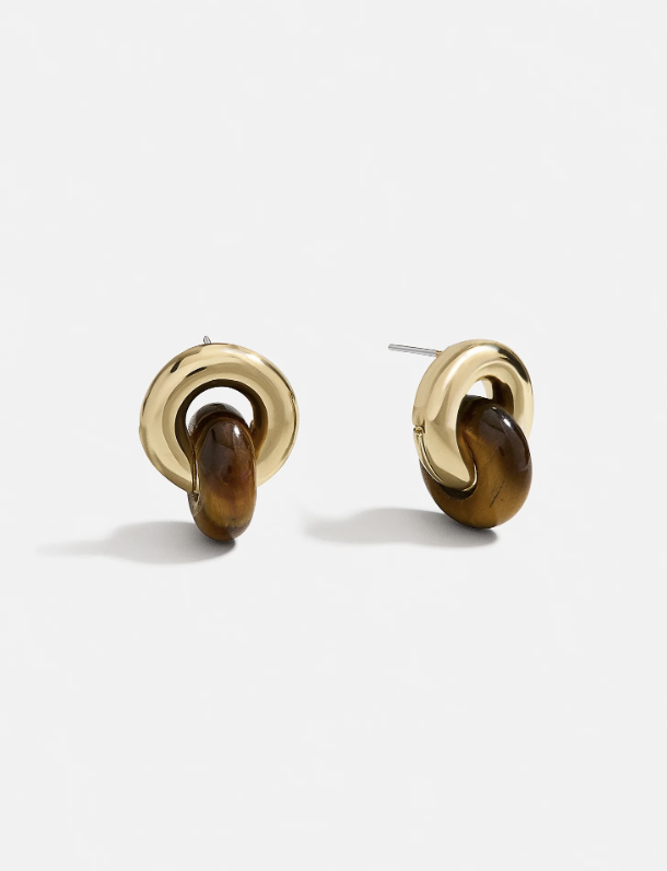 A pair of Baublebar Nyla Gold Earrings, which are chunky gold twisted hoop earrings.