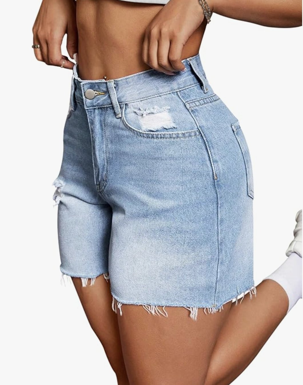 A pair of light-wash high-waisted stretchy casual denim shorts with a raw hem, styled for a summer BBQ outfit.