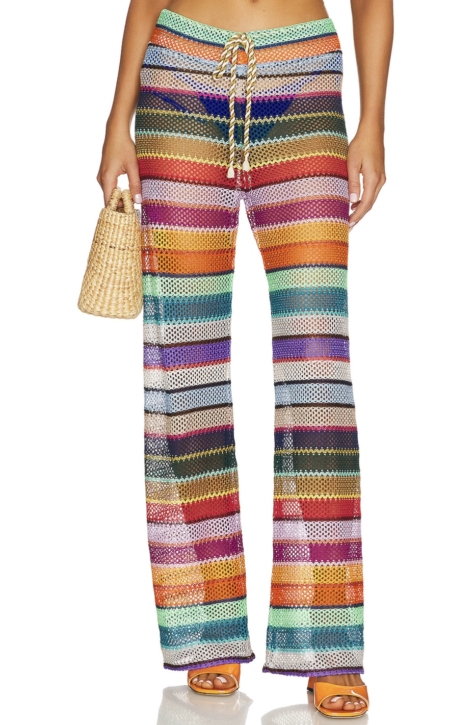 A pair of colorful, horizontally striped crochet knit beach pants with a drawstring waist, styled for a fun, vibrant resort look.