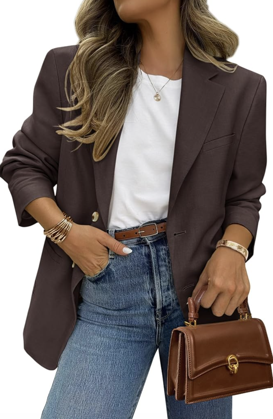 A woman wearing an oversized chocolate brown blazer styled with a white t-shirt, blue jeans, and a brown leather handbag for a polished everyday look.