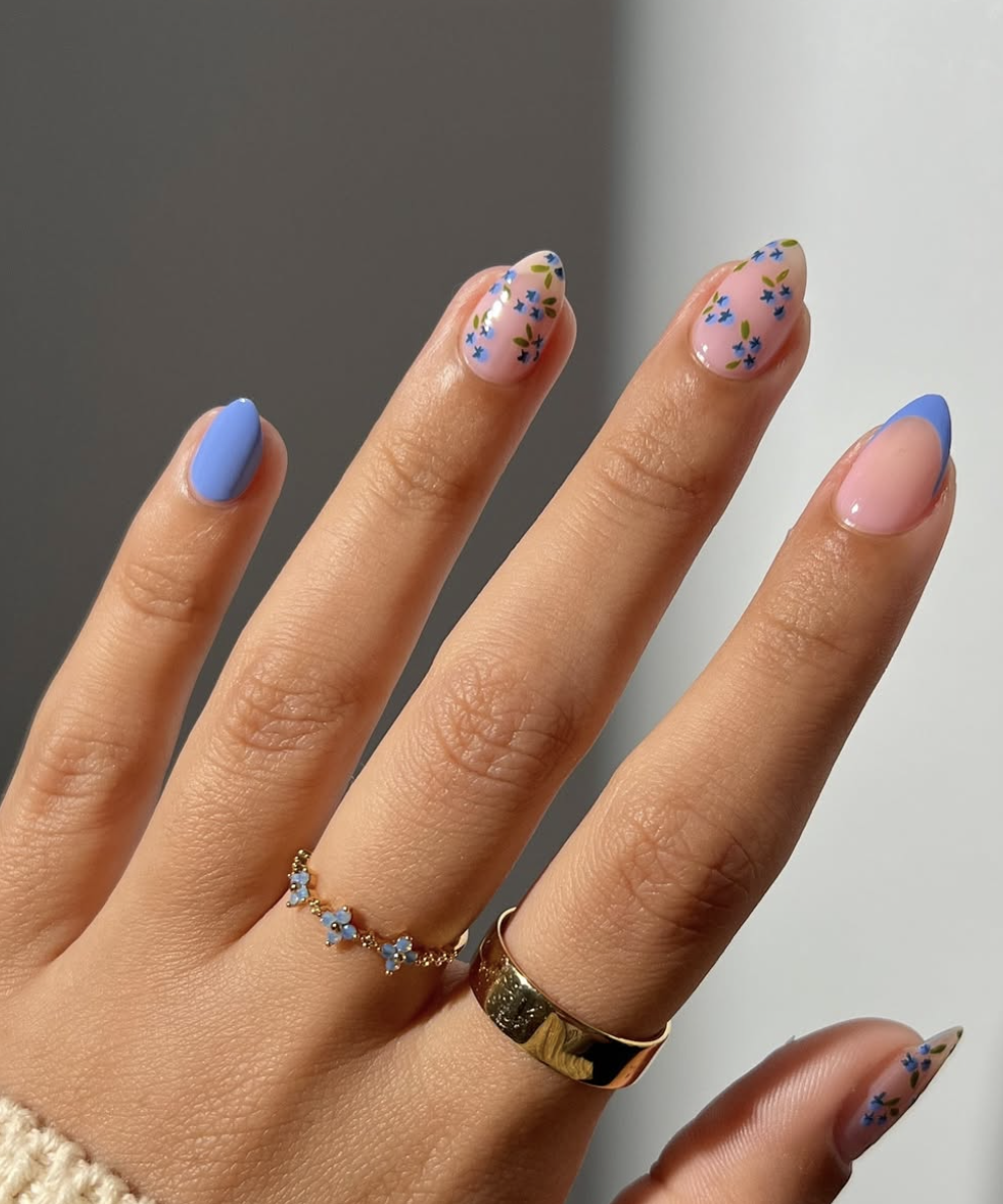 A close-up of short square-shaped nails with a smooth, muted periwinkle-blue "blueberry milk" polish.