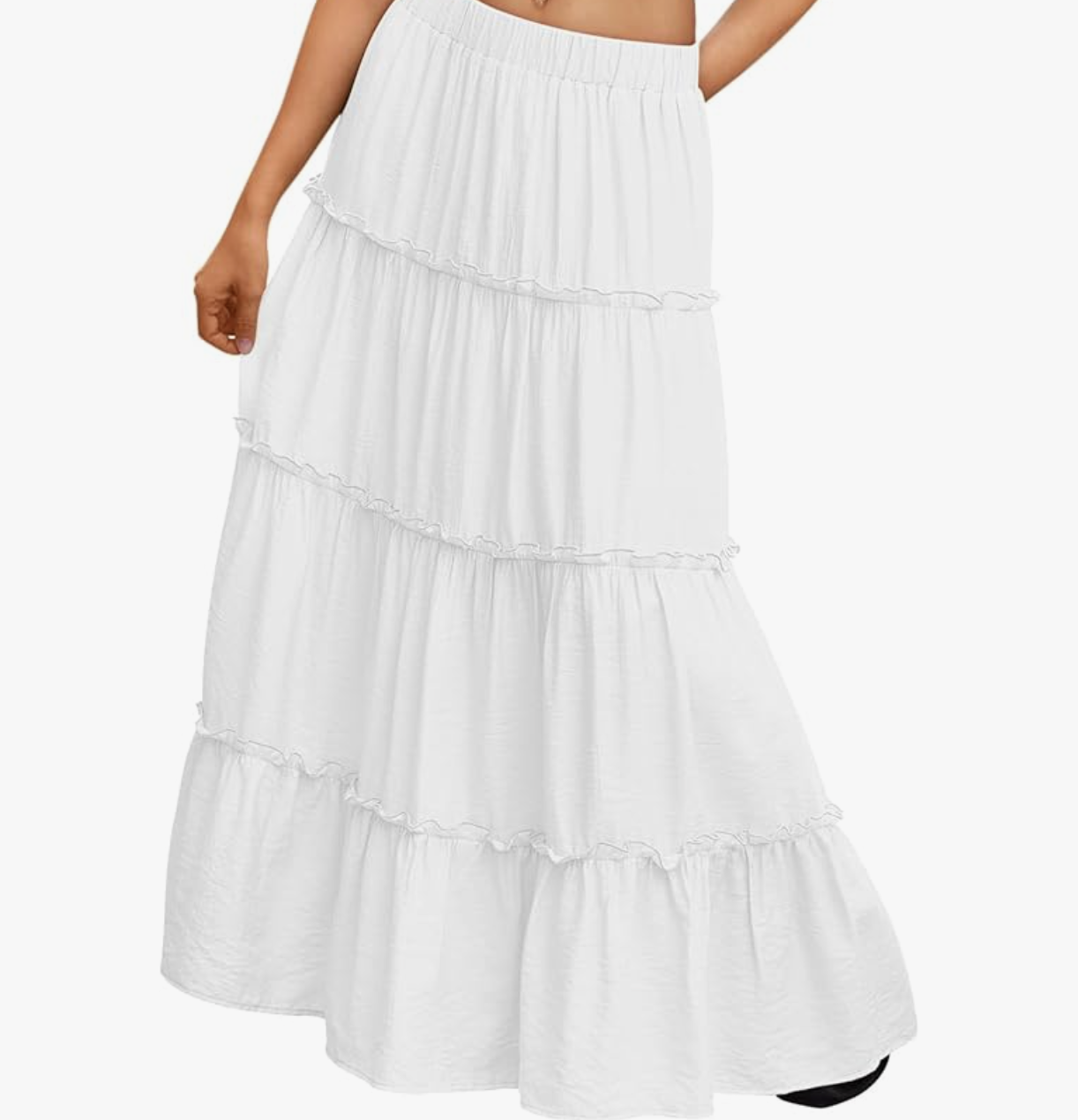A close-up of a woman wearing a flowy, white tiered boho maxi skirt with a comfortable elastic waistband.