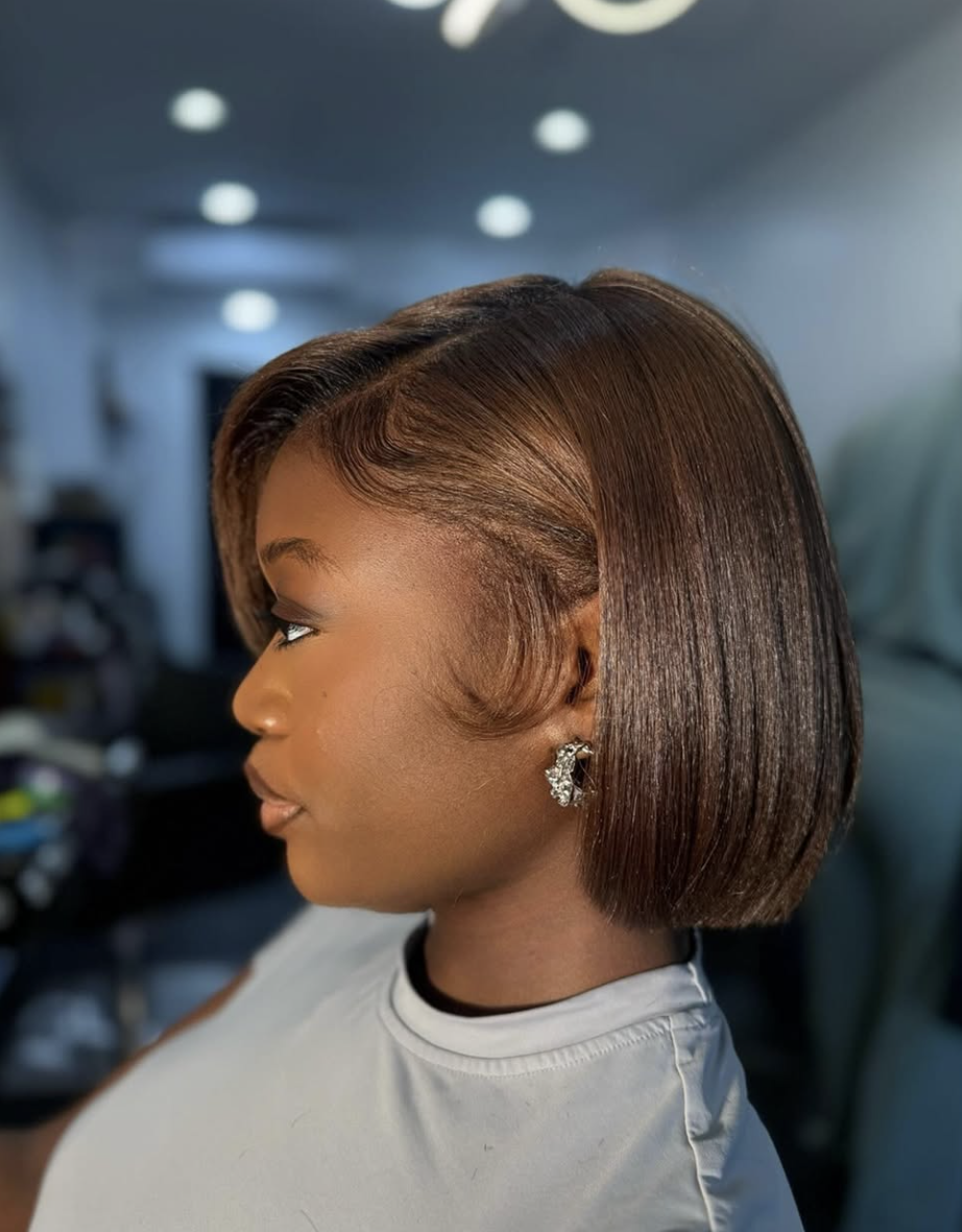 Silk press bob with one side tucked behind the ear to show the cheekbone