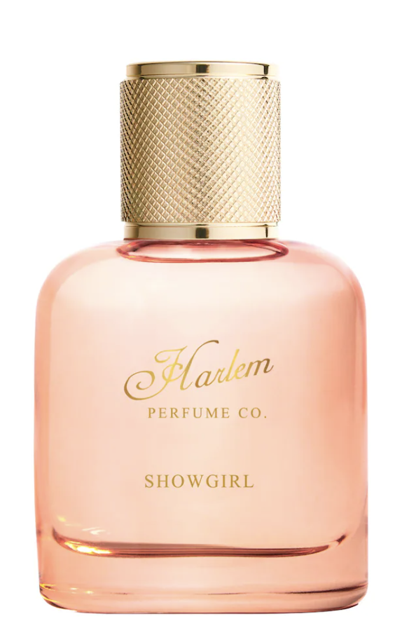 Harlem Perfume Co. Showgirl Eau de Parfum in a round pink glass bottle with a gold cap, a sophisticated fragrance for melanin-rich skin featuring French lavender and amber to evoke the spirit of the Harlem Renaissance.
