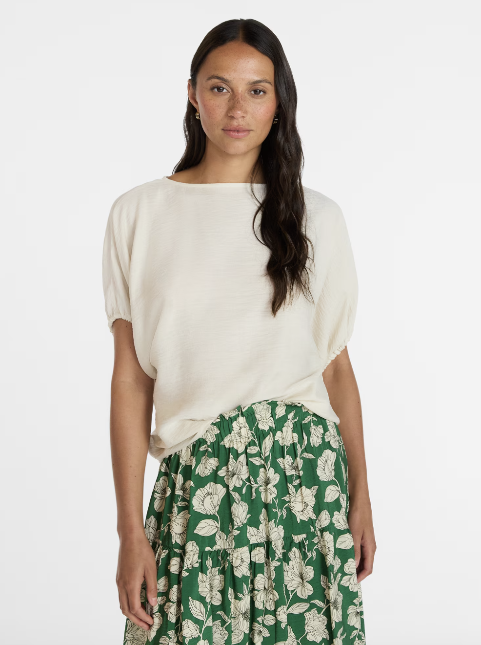 An elegant boatneck top with draped dolman sleeves for a relaxed, chic silhouette.