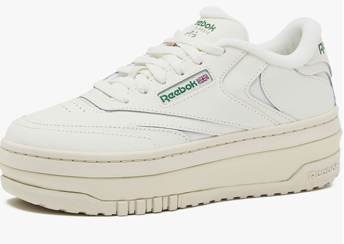 White Reebok Club C Extra platform sneakers with a layered chunky midsole and the classic green Reebok logo on the side.