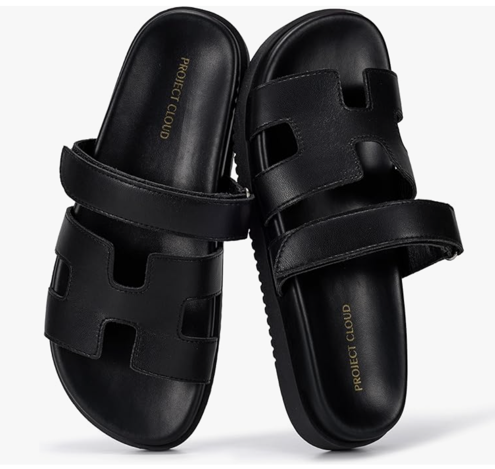 A pair of black leather H-band slide sandals by Project Cloud with a cushioned footbed, shown from a side and top-down perspective.