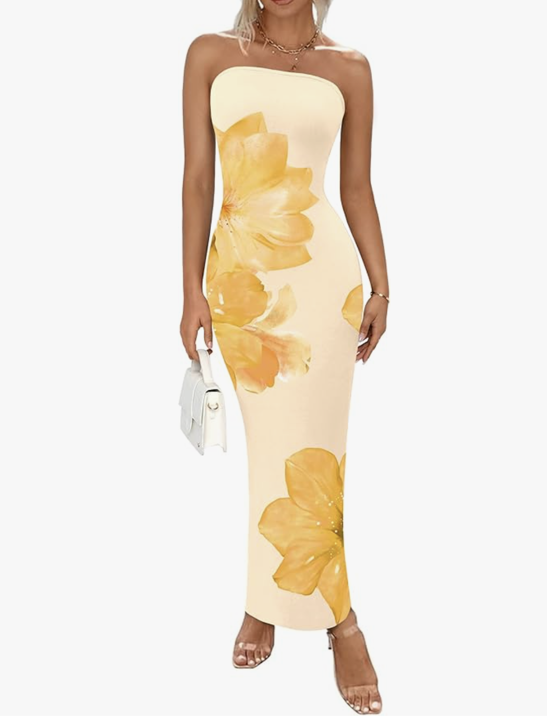 A woman wearing a yellow floral strapless maxi dress with a mesh overlay and a bodycon silhouette, featuring a sculptural tube-style neckline.