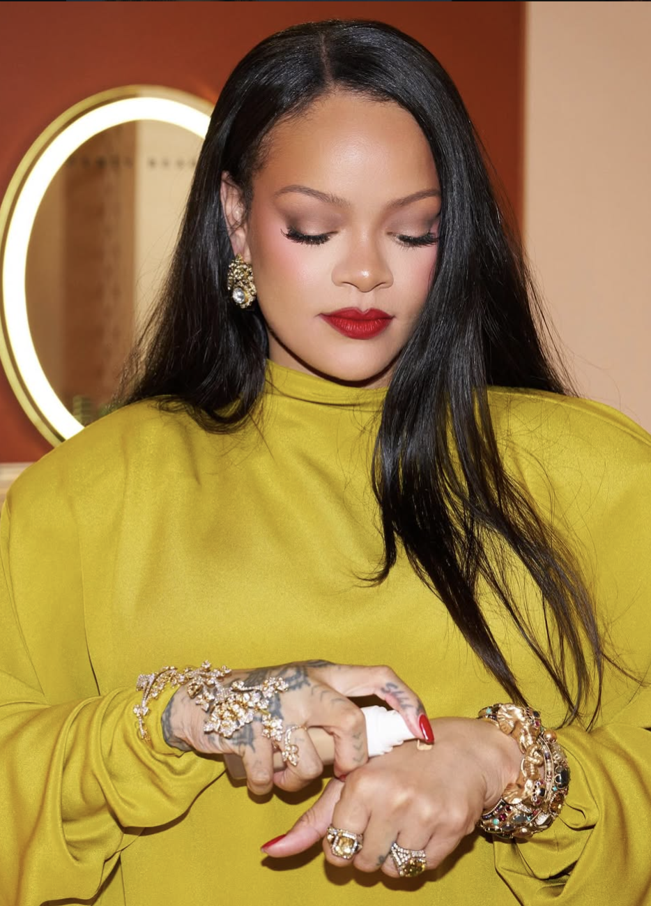 A close-up shot of Rihanna with a sleek downdo wearing a muted, soft berry-red lipstick and minimal eye makeup, perfectly complementing a Summer color season palette.