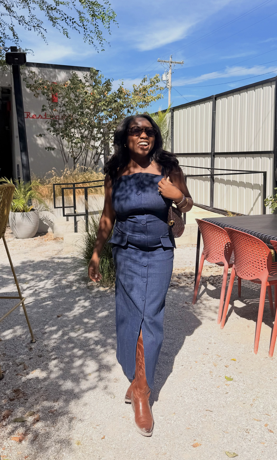 Full-length country concert outfit with denim jumpsuit
