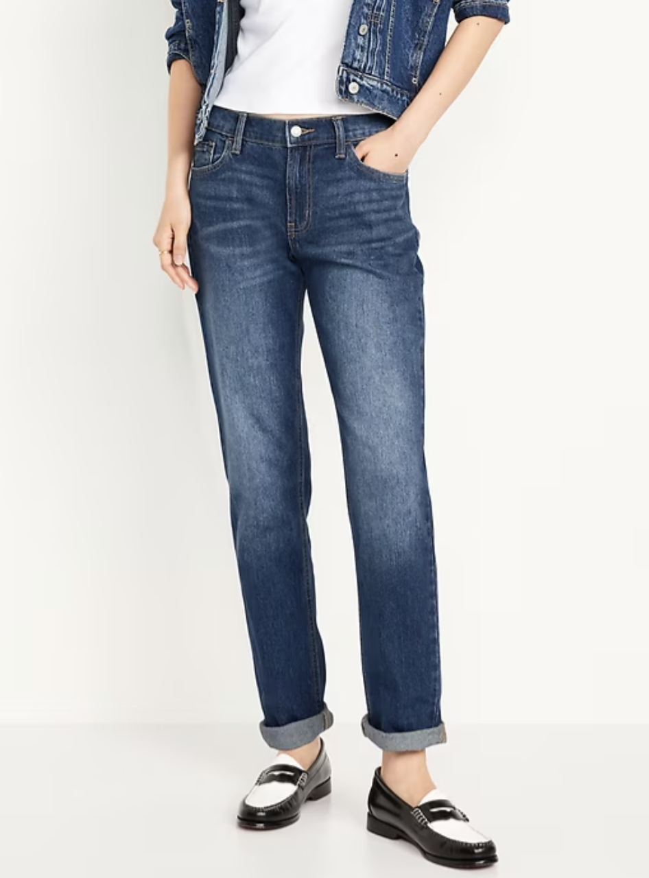 Model wearing Old Navy Mid-Rise Wow Boyfriend Straight Jeans in a medium wash with rolled cuffs, styled with black-and-white loafers to show a comfortable, relaxed fit for an athletic or rectangle figure.