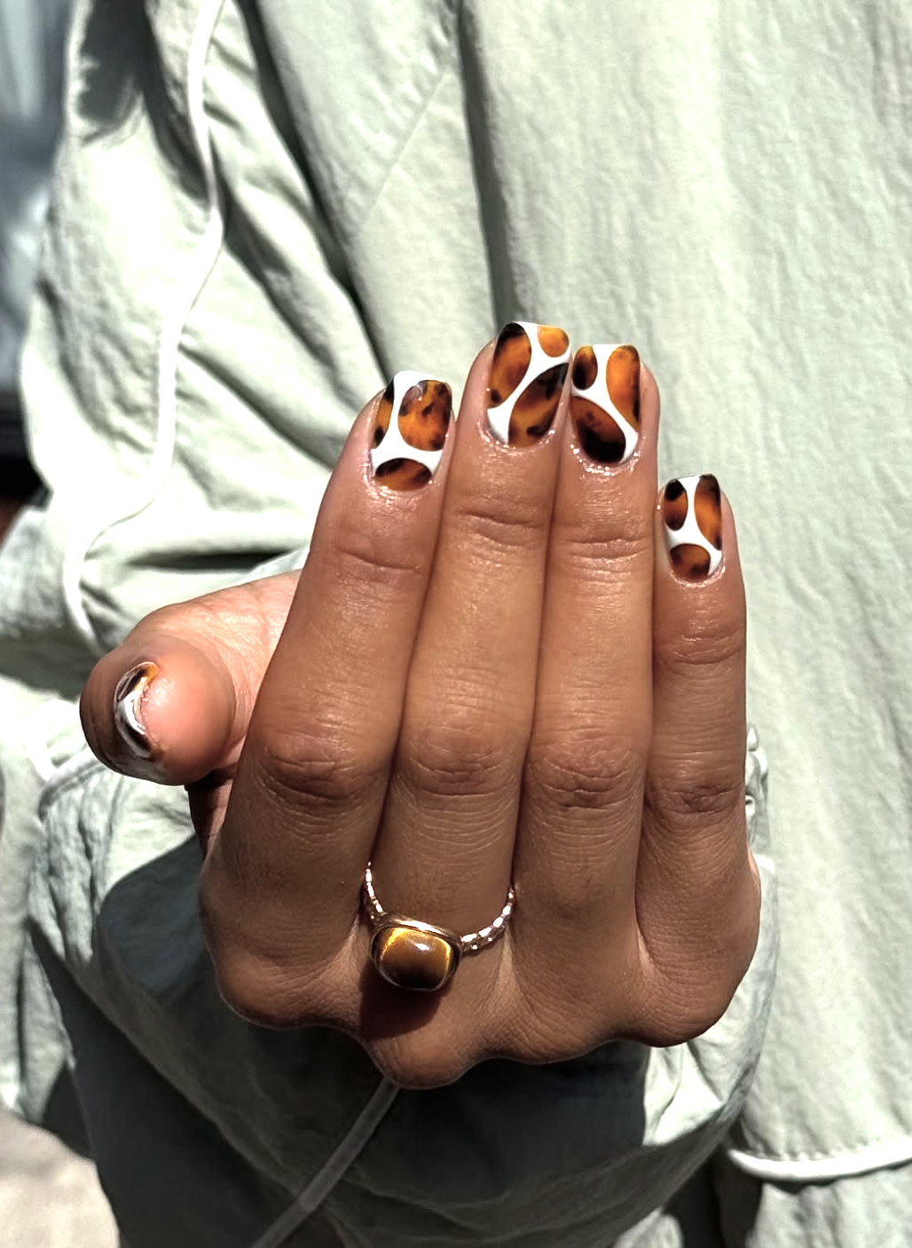 Tortoiseshell October nails with translucent amber, brown and black details