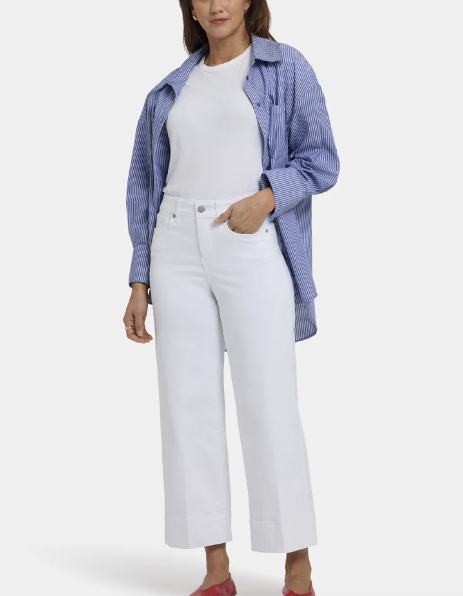 A person with an hourglass body shape wearing NYDJ Teresa Wide Leg Ankle jeans, demonstrating a contoured waistband that fits the small of the back without gapping.