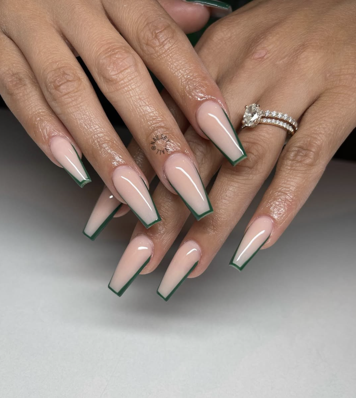 Close-up of olive square french on neatly manicured hands