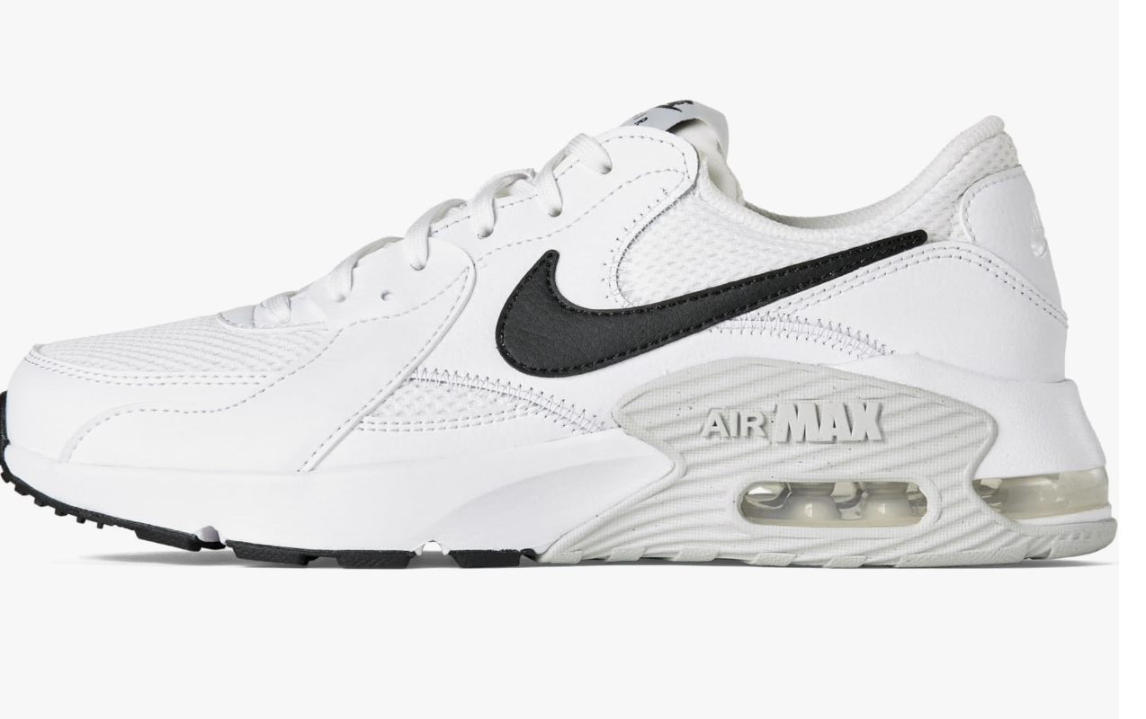 A close-up of a classic white Nike Air Max 90 sneaker featuring a prominent black leather swoosh and visible air cushioning in the sole.