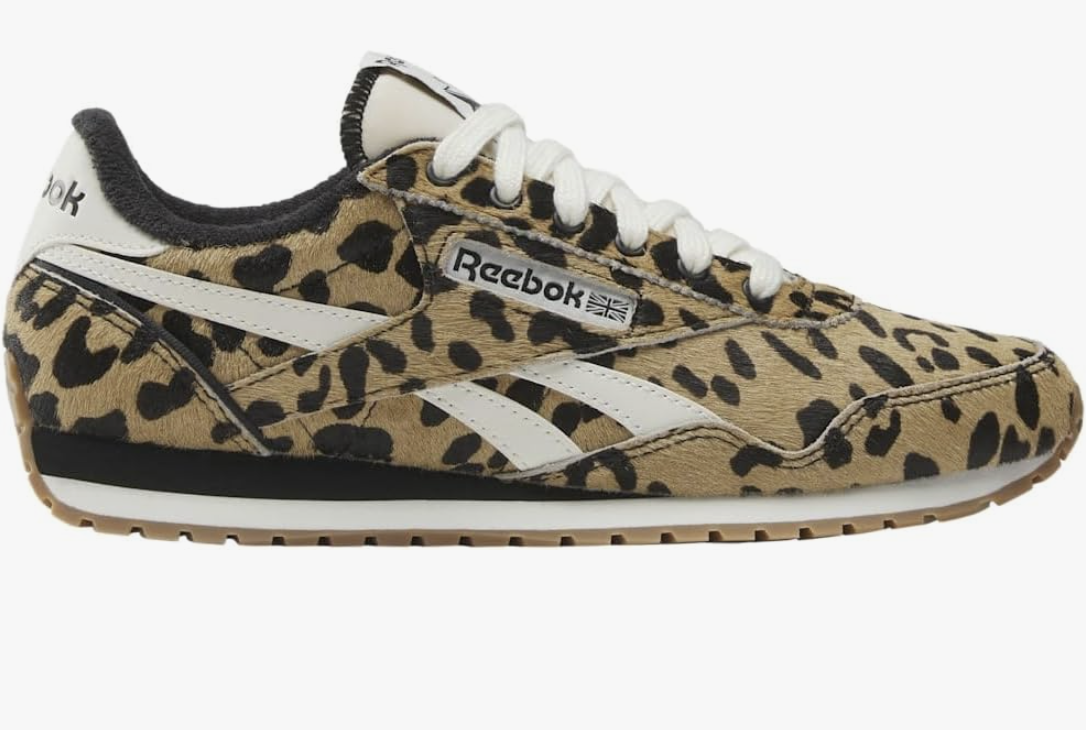 A pair of leopard print Reebok Classic AZ Legacy sneakers, shown as a trendy footwear option for what to wear with a spaghetti strap dress.