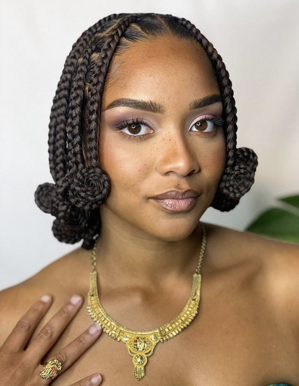 Short braided bob decorated with lightweight beads.
