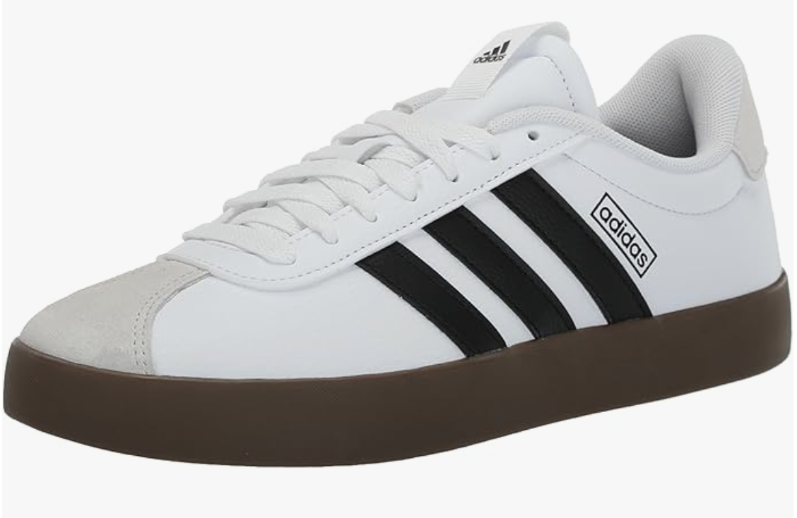 A side profile view of a clean white leather Adidas VL Court sneaker featuring three classic black stripes, a grey suede T-toe overlay, and a dark brown gum rubber sole.