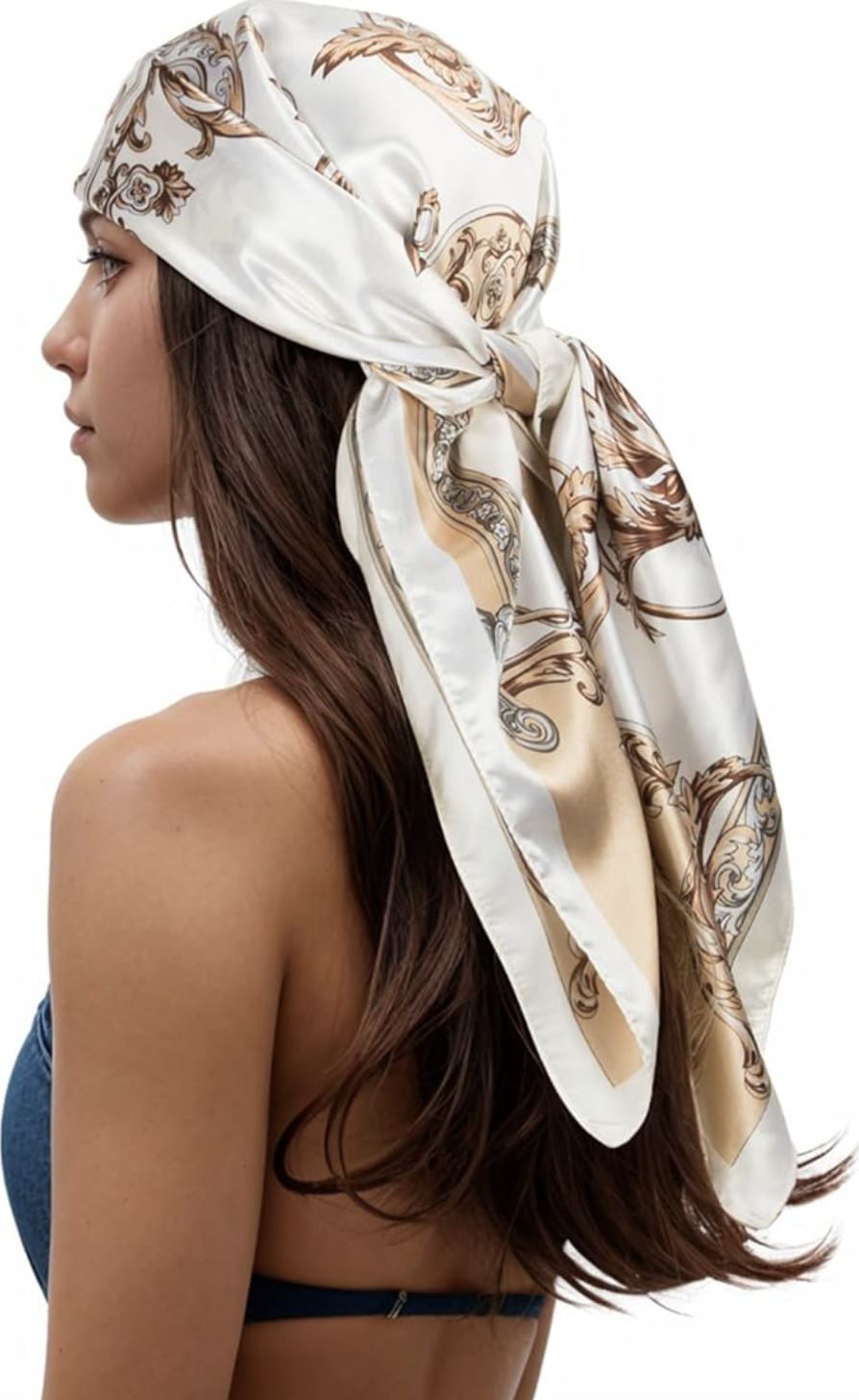 A large square white silk scarf with a classic gold chain-link and tassel print, featuring a deep navy blue border.