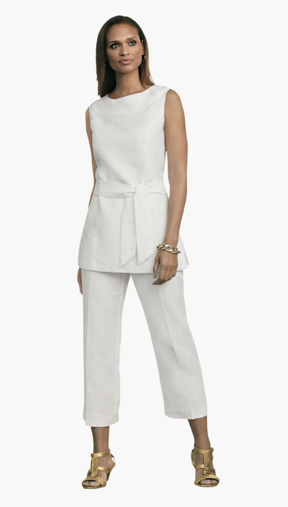 A woman wearing a white two-piece Jessica London linen set featuring a sleeveless tunic with a tie-waist and matching capri pants.
