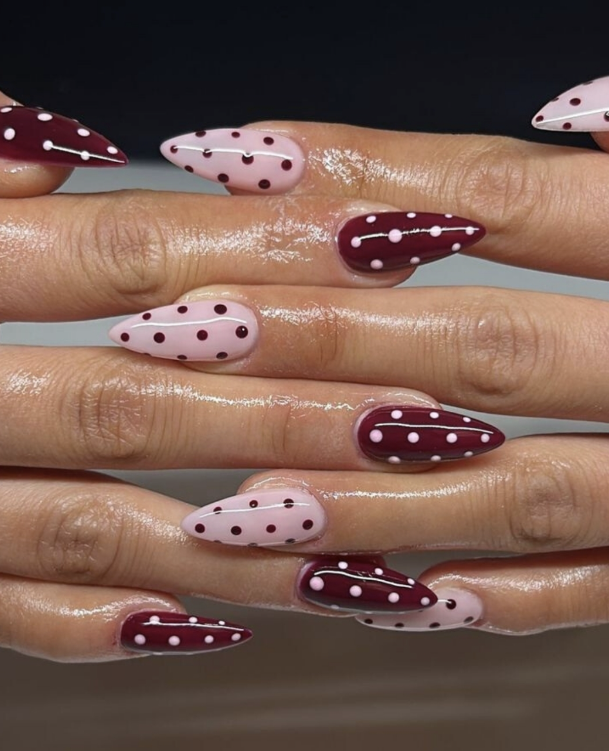 Cherry red polka dot nail art on sheer pink base