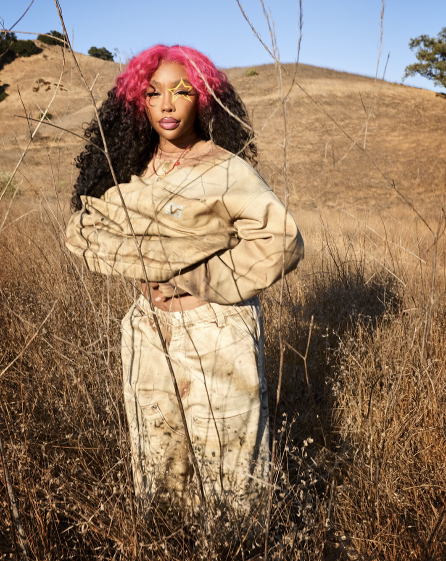 SZA wears clothing and shoes from her VANSZA collection with Vans in a grassy field.