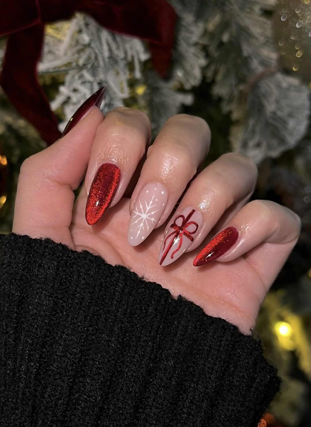 Christmas gift-wrap nail design with ribbon lines and a small bow