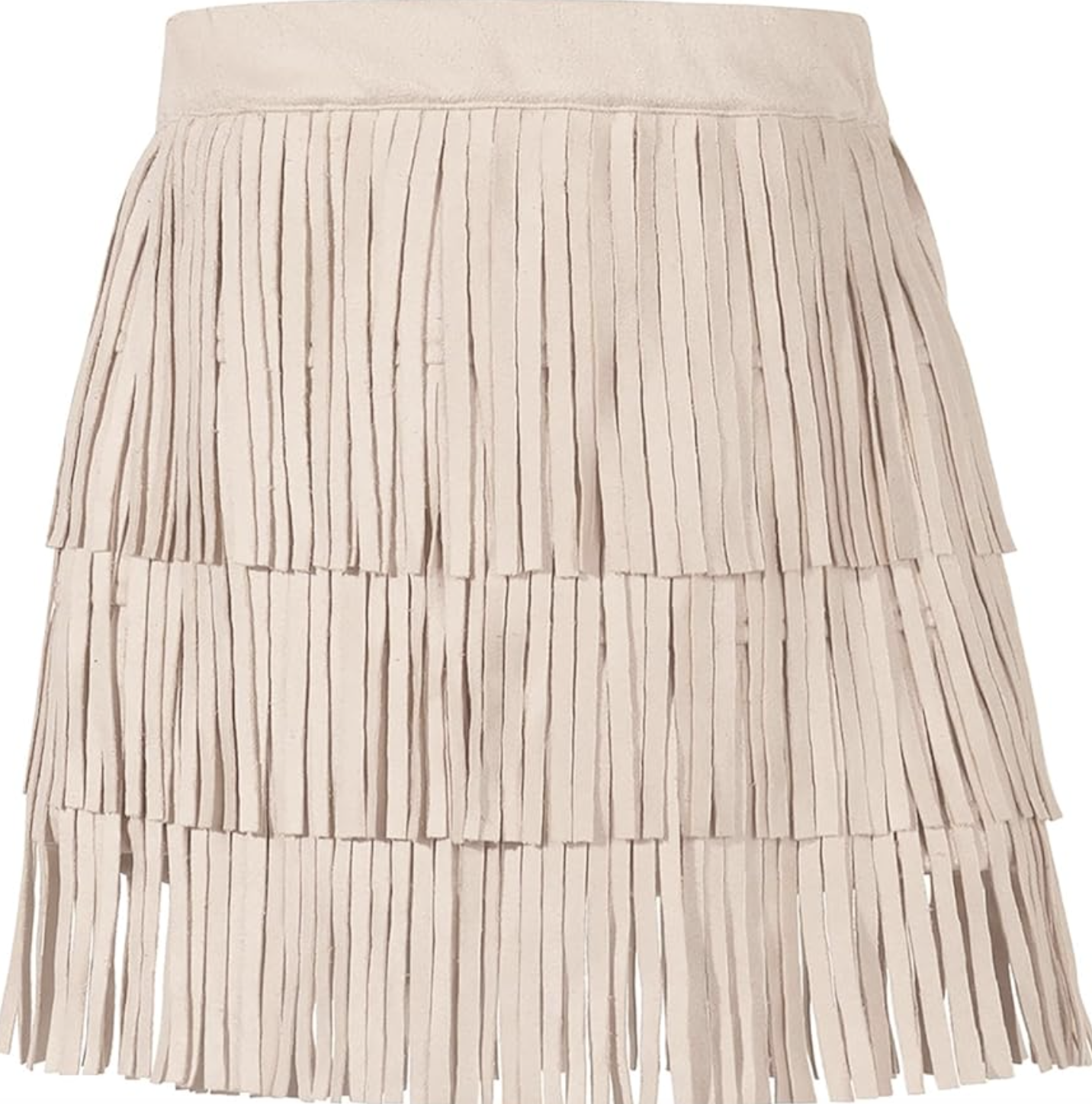 A woman standing on a cobblestone street wearing a chunky white cable-knit sweater with fringe sleeves and a matching white fringe midi skirt.