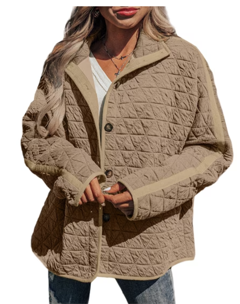 Woman wearing a taupe lightweight quilted button-front jacket over a white top and jeans.