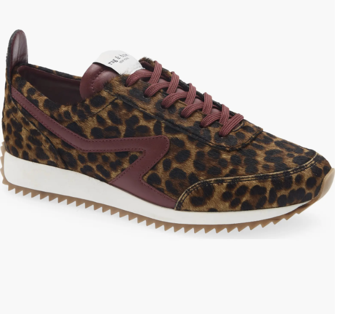 Leopard print suede low-top sneaker featuring burgundy leather trim, white rubber midsole, and a gum serrated sole on a white background.