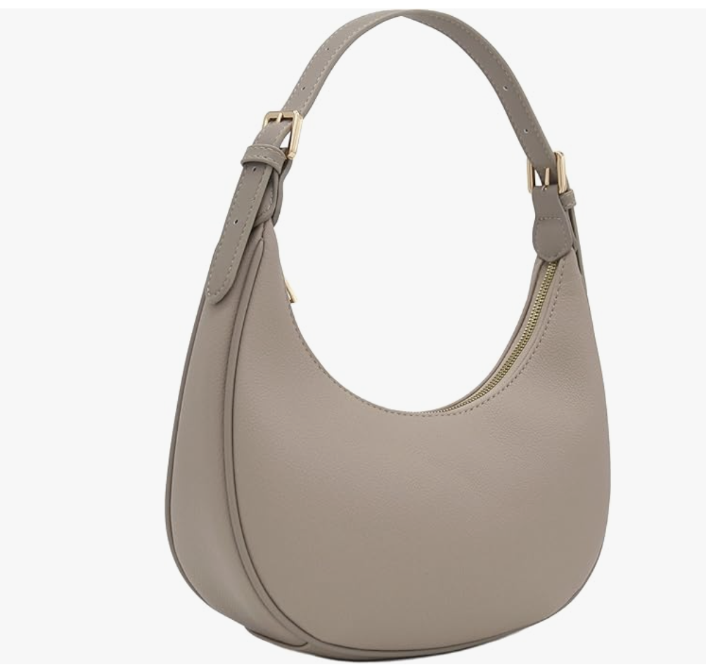 A taupe-colored, crescent-shaped faux leather shoulder bag with an adjustable strap and gold hardware.