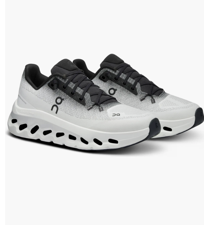 Pair of On Cloudtilt athletic sneakers in Ivory and Black featuring the signature CloudTec Phase midsole with hollow pods and a speed-lacing system.