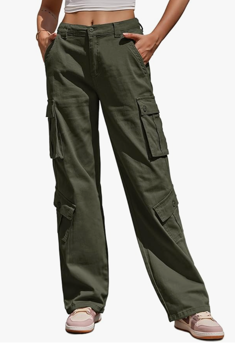 A person wearing olive green low-waisted parachute cargo pants with oversized pockets and an adjustable drawstring waist.