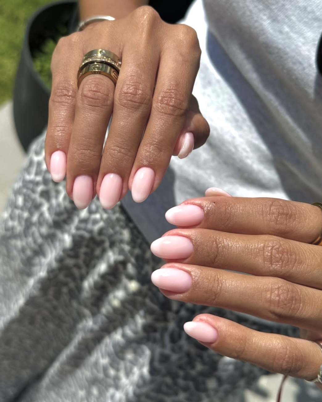 Short oval nails featuring a semi-opaque milky white base with soft, blurred white French tips.